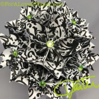 Paper flowers in black damask themed scrapbook paper