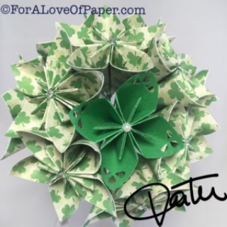 Paper flowers in green clover themed scrapbook paper