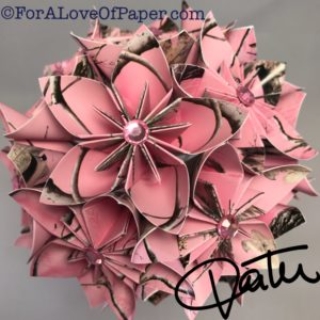 Paper flowers in pink camouflage themed scrapbook paper